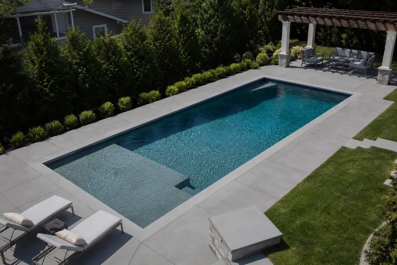 Modern rectangular gunite pool with sun shelf