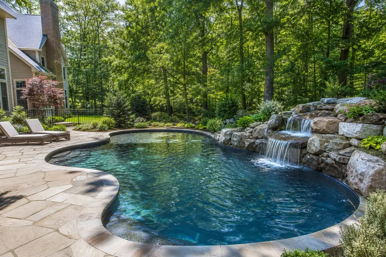 Freeform pool with natural stone waterfall